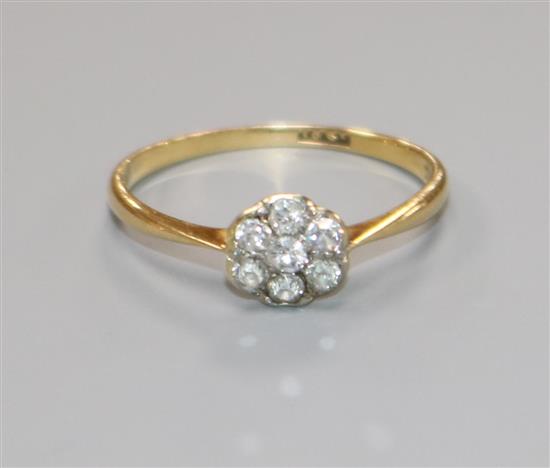 A mid 20th century 18ct gold and diamond cluster ring, size L.